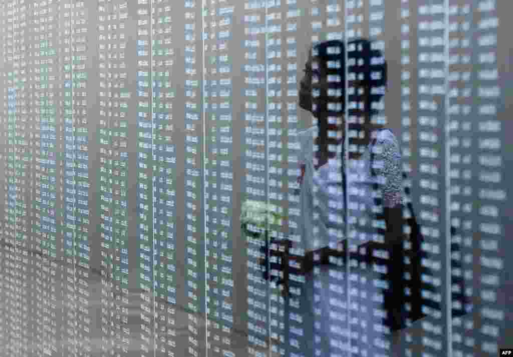 A woman reads through names of soldiers on a memorial for those who died in the decades-long conflict against the Tamil Tigers during National War Hero&#39;s Day in Colombo, Sri Lanka.
