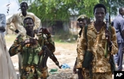 FILE - South Sudanese government soldiers patrol in Bentiu town, South Sudan, June 24, 2015.