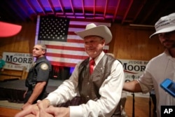 Former Alabama chief justice and U.S. Senate candidate Roy Moore shakes hands with supporters after speaking at a rally, in Fairhope, Alabama, Sept. 25, 2017.