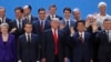 President Donald Trump, front center, stands with other world leaders as they pose for a group picture at the start of the G-20 Leader's Summit inside the Costa Salguero Center in Buenos Aires, Argentina, Nov. 30, 2018. 