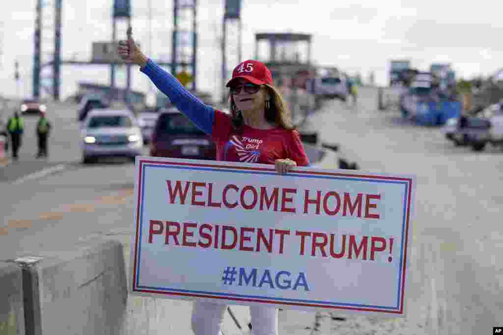 A supporter of President Donald Trump waits for the motorcade on the road to Mar-a-Lago, Trump&#39;s Palm Beach estate in West Palm Beach, Florida.