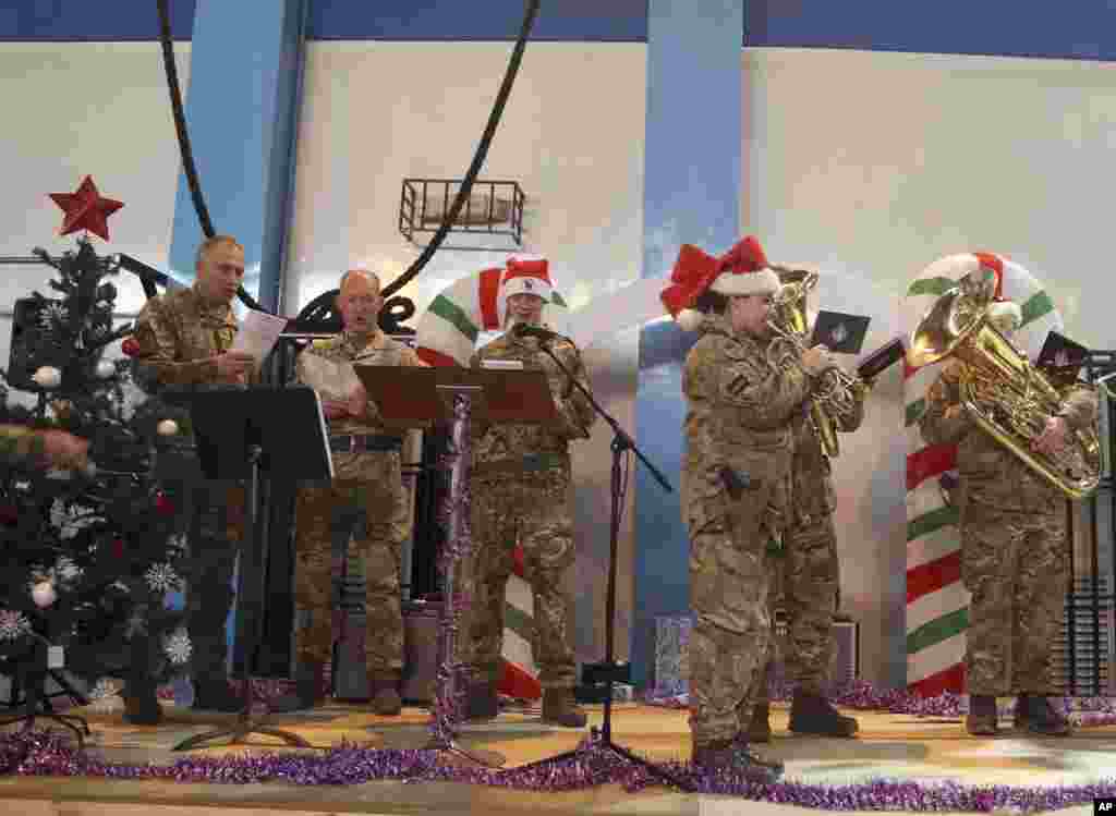 U.S. and NATO forces sing carols during a ceremony on Christmas Day at the Resolute Support Headquarters, in Kabul, Afghanistan, Dec. 25, 2018.