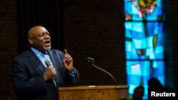 Pastor Tommie Pierson preaches during a Thanksgiving service that discussed the reaction in Ferguson, Missouri, to developments in the Michael Brown case, Nov. 27, 2014. 