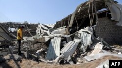 FILE - A Yemeni man inspects destruction at a charity's destroyed food aid storage facility, following a reporteded Saudi-led coalition airstrike in the Yemeni port city of Hodeidah, December 23, 2017.