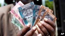 To buy dollars with South Sudanese Pounds (SSP) at the official exchange rate of 3.16 to the dollar, people have to go to the Central Bank in Juba. The black market rate is about 9 SSP to $1.
