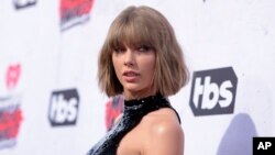 FILE - Taylor Swift arrives at the iHeartRadio Music Awards at The Forum, April 3, 2016, in Inglewood, California.