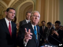 FILE - Senate Majority Leader Mitch McConnell of Ky., joined by, from left, Sen. John Barrasso, R-Wyo., and Sen. John Thune, R-S.D., meets with reporters July 11, 2017, on Capitol Hill in Washington.