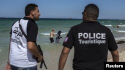 Tourist police officers patrol at the beach in Sousse, Tunisia, July 1, 2015. 