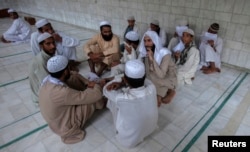 Pakistani religious students and teachers attend a discussion session at the Ganj Madrassa in Peshawar, Aug. 21, 2013.