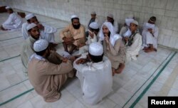 Pakistani religious students and teachers attend a discussion session at the Ganj Madrassa in Peshawar, Aug. 21, 2013.