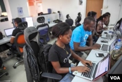 Andela fellow Tolu Komolafe works at the company's office on June 30, 2016 in Lagos, Nigeria. (Photo: Chris Stein for VOA)