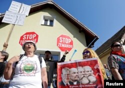 FILE - Demonstrators shout slogans during a protest rally opposing the attendance of President Milos Zeman at the Communist party's congress in Nymburk, Czech Republic, April 21, 2018.