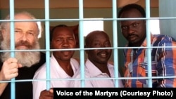 Pastor Hassan Abduraheem, second from left, is shown in prison in Sudan. 