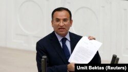 FILE - Justice Minister Bekir Bozdag addresses the Turkish Parliament during a debate in Ankara, March 19, 2014. Bozdag disclosed a plan on April, 6, 2016, to strip citizenship from Turks found to be supporting terrorism.