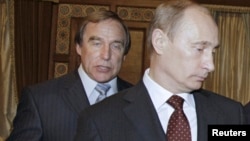 FILE - Russian cellist and Putin associate Sergei Roldugin (L) is seen with Vladimir Putin, prime minister at the time, at the House of Music in St. Petersburg, Russia, Nov. 21, 2009. Roldugin is among Russians named in the Panama Papers.