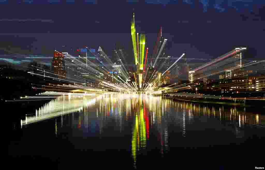 The skyline, with its characteristic banking towers, is reflected in river Main in Frankfurt, Germany, Oct. 1, 2017.