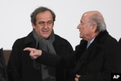 FILE - UEFA president Michel Platini (L) and FIFA president Sepp Blatter are seen in a Dec. 16, 2014, photo.