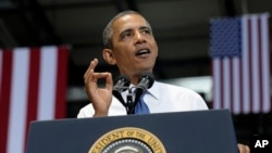 President Barack Obama gestures as he speaks at the Amazon fulfillment center in Chattanooga, Tennessee, July 30, 2013.