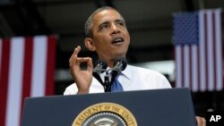 President Barack Obama gestures as he speaks at the Amazon fulfillment center in Chattanooga, Tennessee, July 30, 2013.