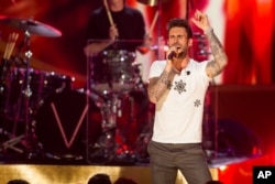 Adam Levine of Maroon 5 performs onstage during "A Very Grammy Christmas" at The Shrine Auditorium in Los Angeles, California, Nov. 18, 2014.