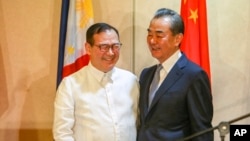 Philippine Foreign Affairs Secretary Teodoro Locsin Jr., left, and visiting Chinese Foreign Minister Wang Yi are seen after their joint news conference in Davao city, in southern Philippines, Oct. 29, 2018.