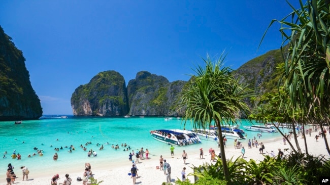 In this March 4, 2017, photo, tourists enjoy the popular Maya bay on Phi Phi island, Krabi province. (AP Photo/Rajavi Omanee)