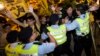 Pro-democracy activists clash with the police during a protest outside the hotel where China's National People's Congress (NPC) Standing Committee Deputy General Secretary Li Fei is staying, in Hong Kong, Sept. 1, 2014.