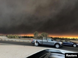 Vehicles are seen during evacuation from Paradise to Chico, in Butte County, California, in this Nov. 8, 2018, picture obtained from social media.