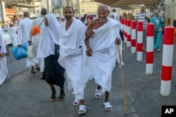 Muslim pilgrims walk toward the Grand Mosque to offer prayers ahead of the annual Hajj pilgrimage, in the Muslim holy city of Mecca, Saudi Arabia, Aug. 18, 2018.The annual Islamic pilgrimage draws millions of visitors each year.