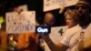 A man holds a scrolling message about guns on his smart phone at a candlelight vigil in West Hollywood, California, following the early morning attacks on a gay night club in Orlando, Florida, U.S. June 12, 2016. 