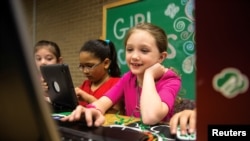 A Girl Scout works on a laptop computer, in a photo released June 21, 2017.