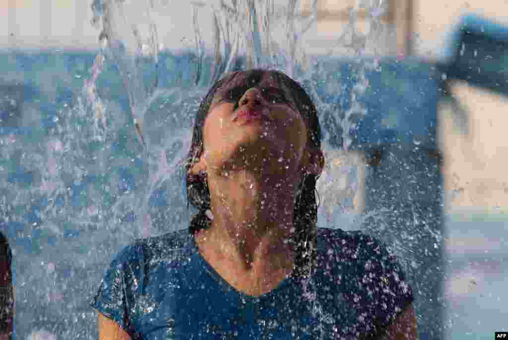 An Indian girl enjoys a swimming pool at Kanha Fun City Water Park in Bhopal.