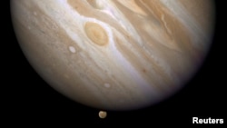 The planet Jupiter is shown with one of its moons, Ganymede (bottom), in this NASA handout taken April 9, 2007 and obtained by Reuters, March 12, 2015. 