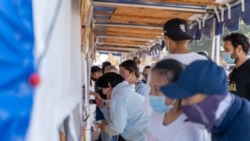 People wait in line to buy food outside food tents during the reopening of the Wat Thai (Thai Temple) of Los Angeles Food Court