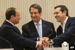 FILE - Cyprus President Nicos Anastasiades (C) Greek Prime minister Alexis Tsipras (R) and Egypt's President Abdel-Fattah el-Sissi, shake hands after their meeting at the presidential palace in capital Nicosia, Cyprus, on Nov. 21, 2017.