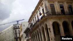 FILE - A crane is seen behind an old building in Havana, Cuba, Sept. 18, 2015. As new construction is booming in Cuba, European businesses may view a tougher U.S. policy toward Havana as “an opportunity for them to step in,” a Cuba expert says.