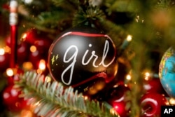The Library of the White House is decorated during a preview of the 2016 holiday decor, Tuesday, Nov. 29, 2016, in Washington. Ornaments on display spell out the word "girls" in 12 different languages. (AP Photo/Andrew Harnik)