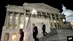 Congressmen walk down the steps of the House of Representatives as they work throughout the night on a spending bill, on Capitol Hill in Washington, February 18, 2011
