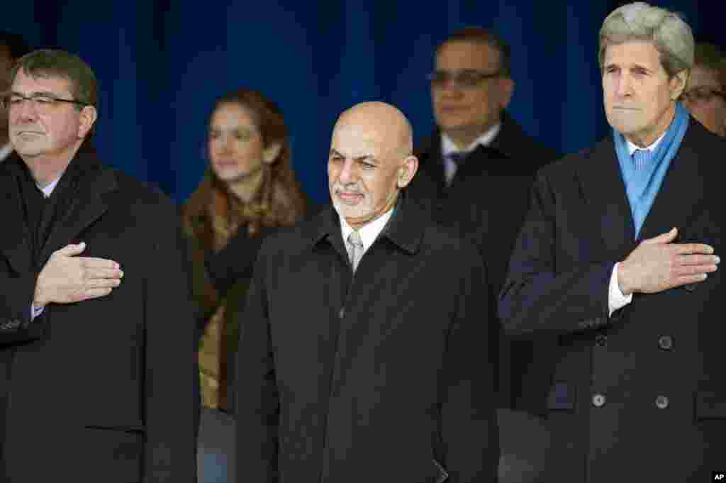 From left, Defense Secretary Ashton Carter, Afghan President Ashraf Ghani and Secretary of State John Kerry stand for the National Anthem at the Pentagon, March 23, 2015.