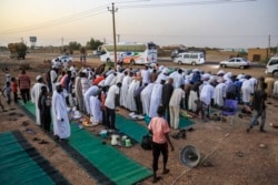 Jemaah Muslim melakukan salat Maghrib setelah berbuka puasa Ramadan di desa al-Nuba, 50 kilometer selatan ibu kota Sudan, 22 April 2021. (AFP)