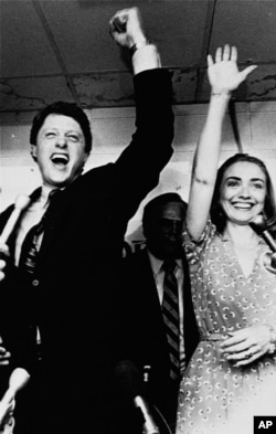 FILE - Former Arkansas Gov. Bill Clinton and his wife, Hillary, celebrate his victory in the Democratic runoff in Little Rock, Arkansas, June 8, 1982.
