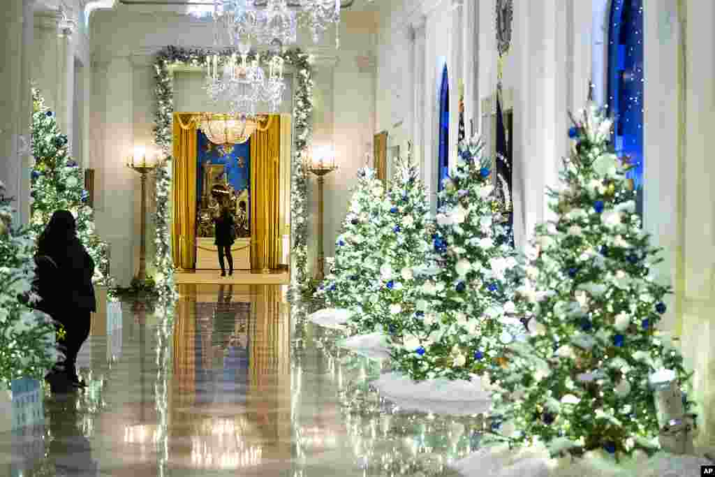 The Cross Hall of the White House is decorated for the holiday season during a press preview of the White House holiday decorations, Nov. 29, 2021.