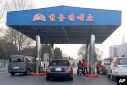 FILE - Cars line up at a gas station in Pyongyang, North Korea, April 1, 2016. North Korea has been condemned and sanctioned for its nuclear ambitions, yet has still received food, fuel and other aid from its neighbors and adversaries for decades.