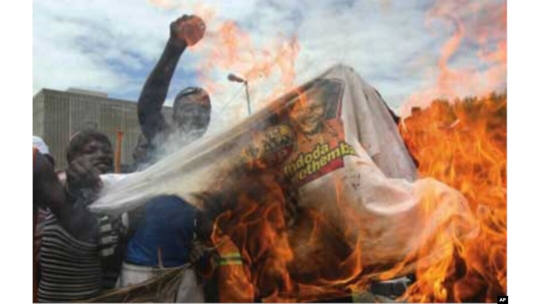 Supporters of the fledgling National Freedom Party, the NFP, burn T-shirts bearing the image of Inkatha Freedom Party, IFP, leader Mangosuthu Buthelezi in Durban, South Africa, recently