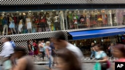 FILE - A photo taken with a slow shutter speed shows people walk through a shopping district in Sao Paulo, Brazil, Dec. 1, 2015. Brazil’s finance minister said on Thursday that Congress has signaled its willingness to support tough measures to control spending.