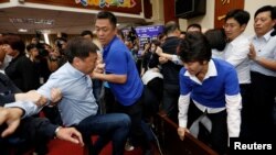 Ruling Democratic Progressive Party (DPP) legislator Chao Tien-lin, left, scuffles with opposition Kuomintang (KMT) legislators during budget meeting for the infrastructure development program, at the Legislative Yuan in Taipei, Taiwan, July 18, 2017.