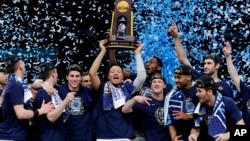Villanova players celebrate with the trophy after beating Michigan 79-62 in the championship game of the Final Four NCAA college basketball tournament, Monday, April 2, 2018, in San Antonio. 