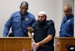 FILE - Ahmad Khan Rahimi, the man accused of setting off bombs in New Jersey and New York in September, injuring more than 30 people, is led into court in Elizabeth, N.J., Dec. 20, 2016.