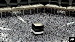 Muslim pilgrims prepare themselves for Friday prayers in front of the Kaaba, Islam's holiest shrine, at the Grand Mosque in the Muslim holy city of Mecca, Saudi Arabia, Sept. 9, 2016.