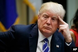 President Donald Trump listens during a meeting at the White House, March 27, 2017.